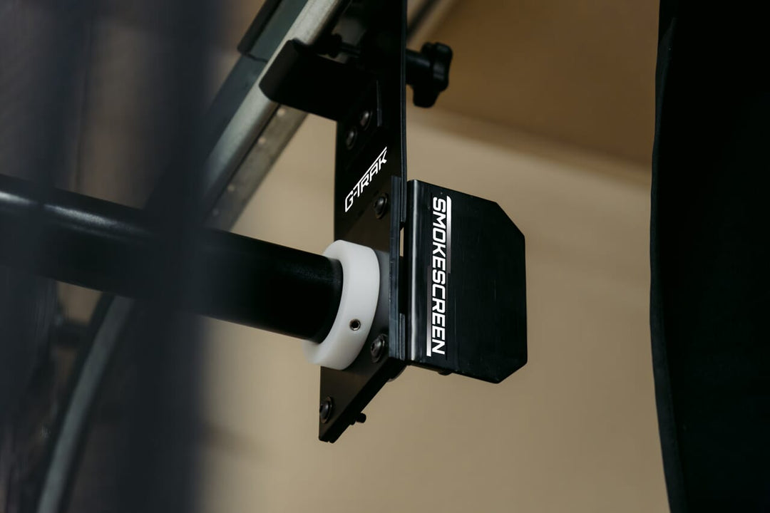 G-trak retractable screen with logo on brackets attached to garage track
